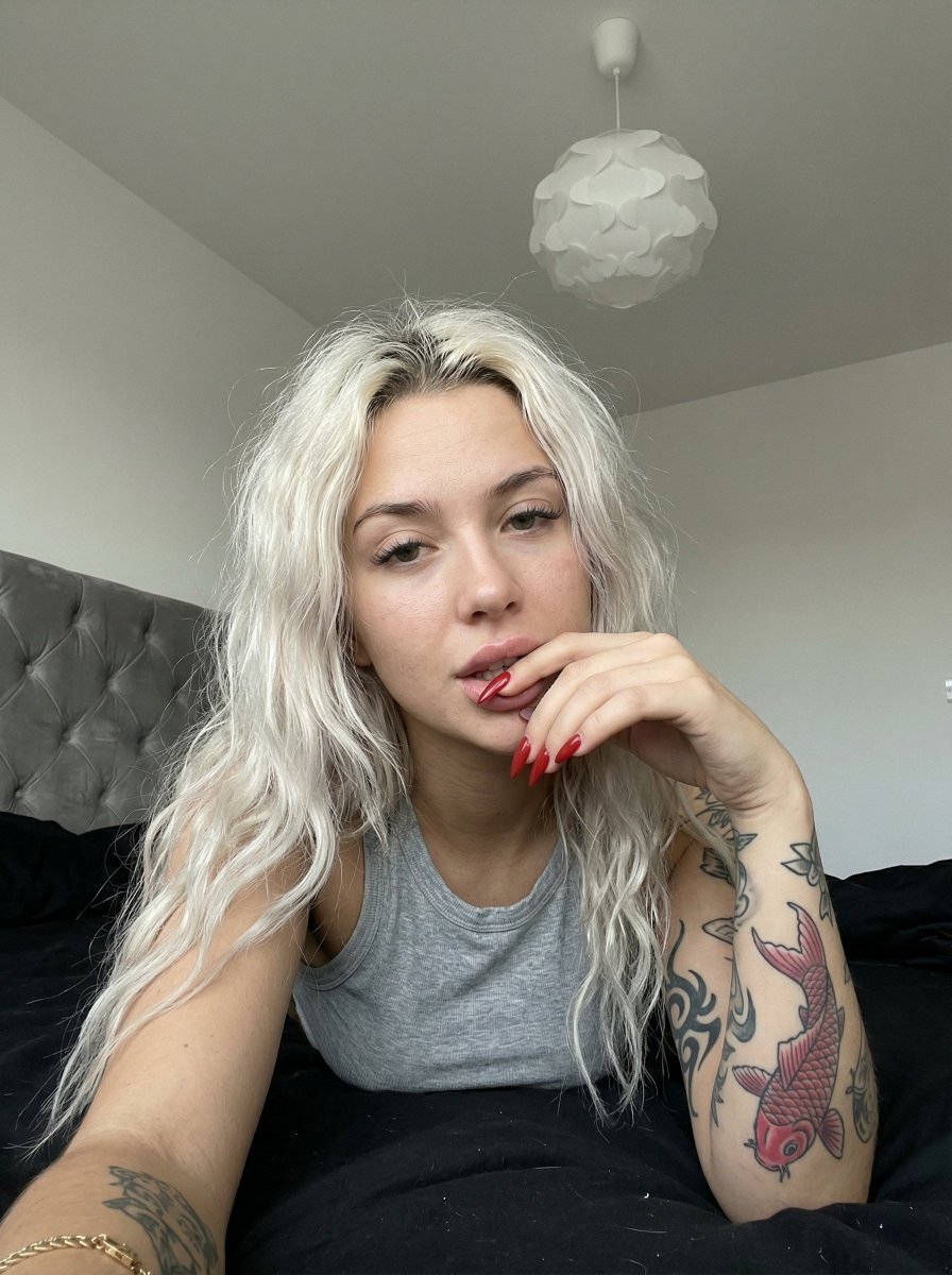 Preview image for Casual smartphone photo of a tattooed woman in a bedroom prompt