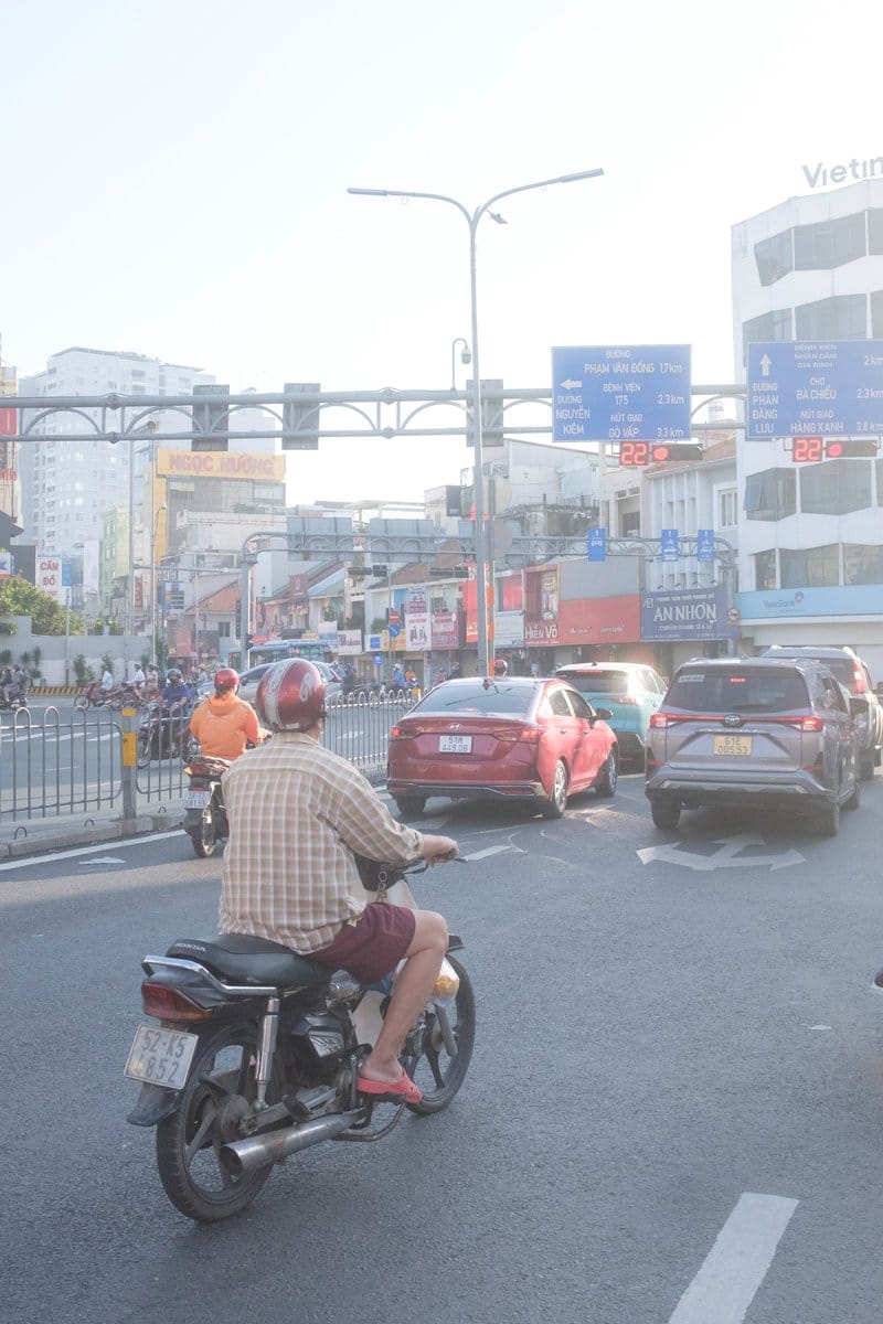 Edit city photo into rainy scene with Vietnamese bikers - AI Generated Realistic Style Image Example